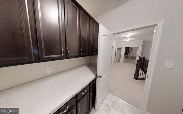 a open kitchen with kitchen island granite countertop a stove refrigerator and cabinets