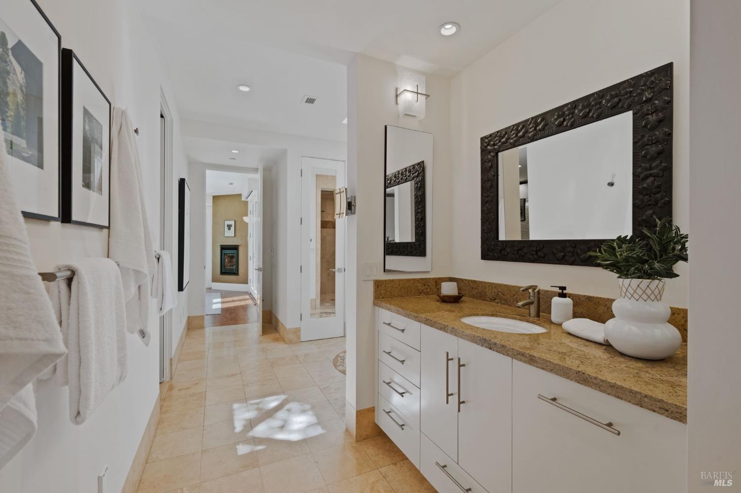 2000 Atlas Peak Road Napa, CA 94558 - Photo 35 of 80 a spacious bathroom with a granite countertop sink and a mirror