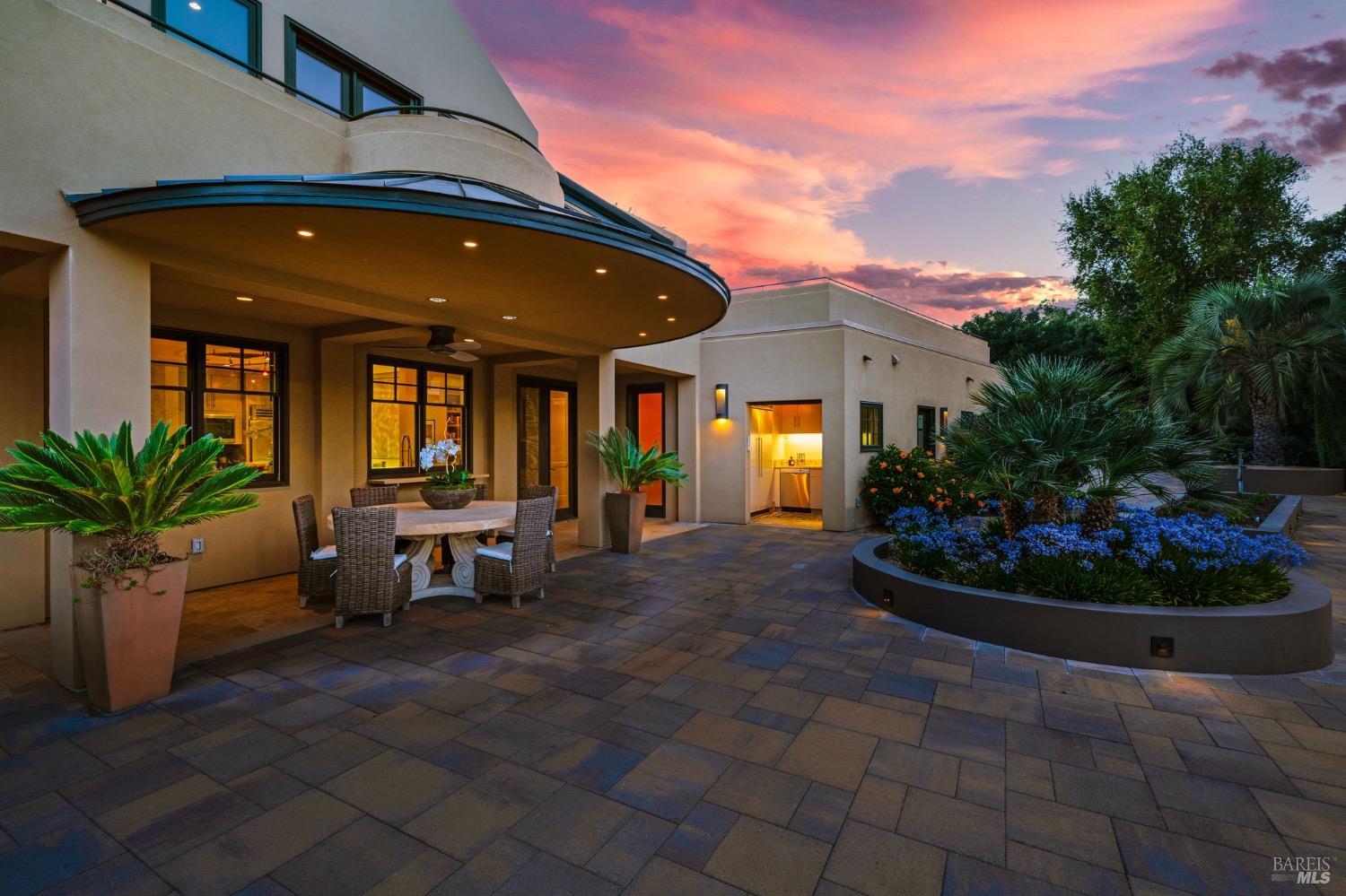 2000 Atlas Peak Road Napa, CA 94558 - Photo 44 of 80 a view of a patio with table and chairs potted plants and palm trees