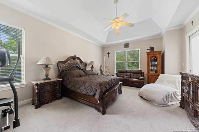 a view of a dining room and livingroom with furniture wooden floor a chandelier