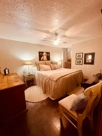 a bedroom with two beds and painting on the wall