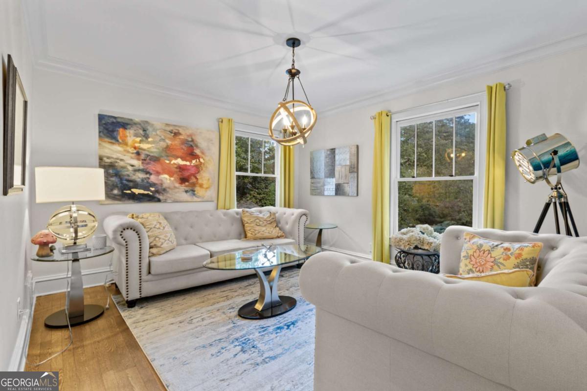 1532 Huntingdon Trail Atlanta, GA 30350 - Photo 12 of 68 a living room with furniture and a chandelier
