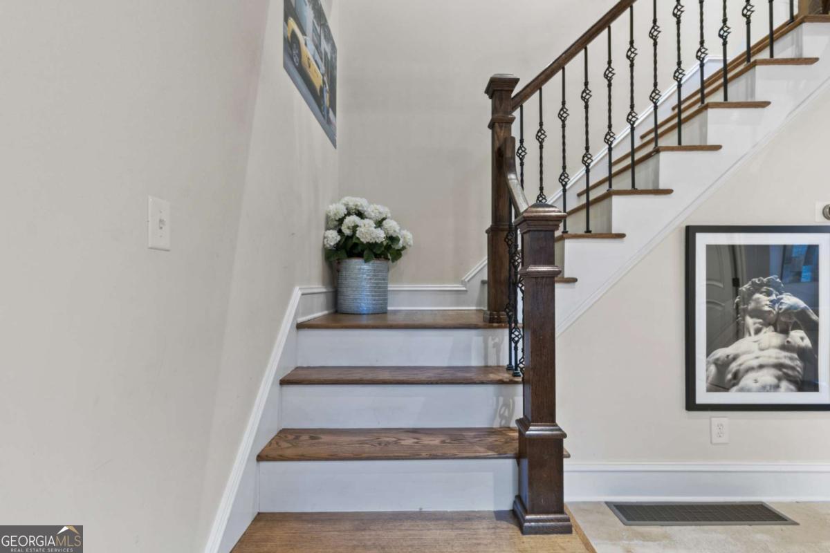 1532 Huntingdon Trail Atlanta, GA 30350 - Photo 13 of 68 a view of staircase with wooden floor and a potted plant