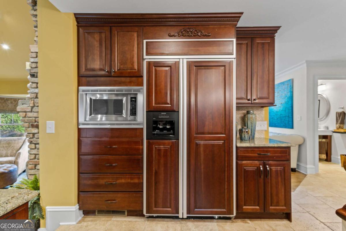 1532 Huntingdon Trail Atlanta, GA 30350 - Photo 17 of 68 a kitchen with a refrigerator stove and cabinets