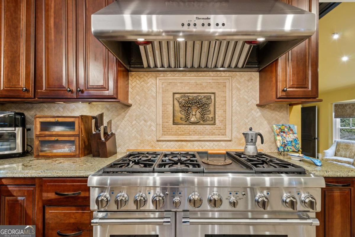1532 Huntingdon Trail Atlanta, GA 30350 - Photo 20 of 68 a stove sitting inside of a kitchen with granite countertop stainless steel appliances