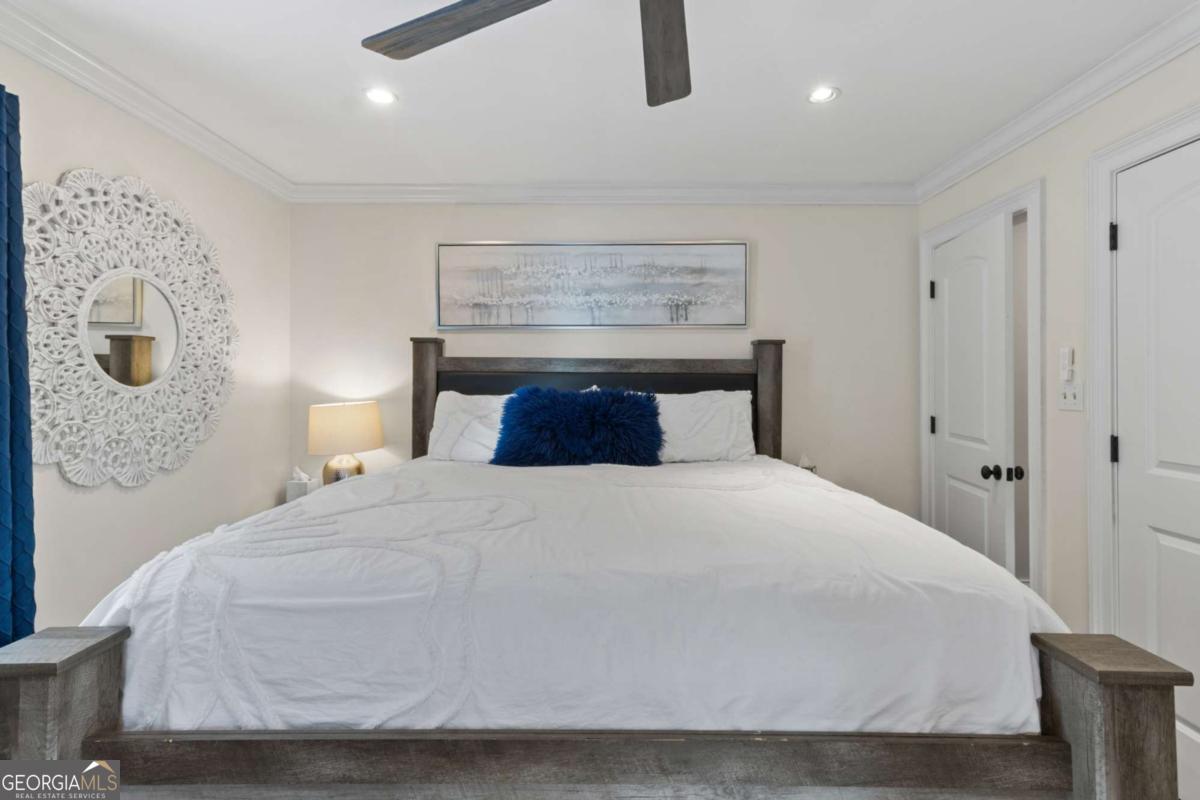 1532 Huntingdon Trail Atlanta, GA 30350 - Photo 29 of 68 a bedroom with a bed and a night stand