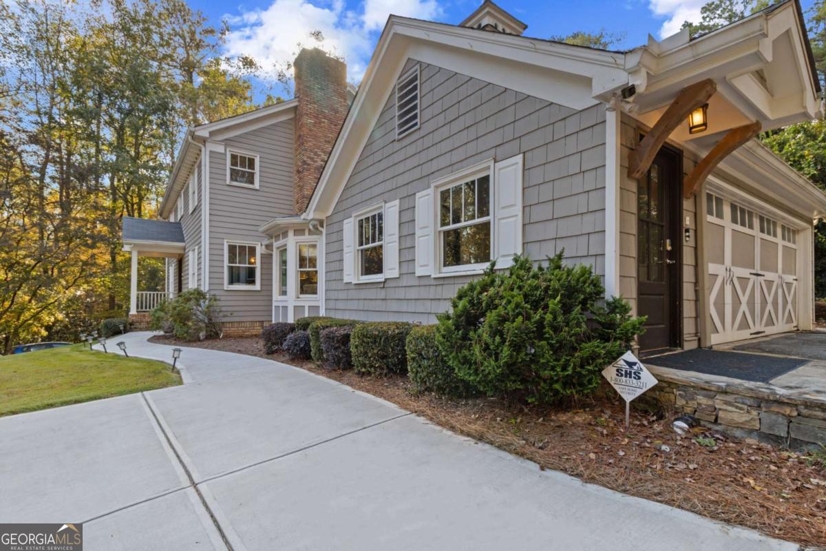 1532 Huntingdon Trail Atlanta, GA 30350 - Photo 3 of 68 a front view of a house with a garden