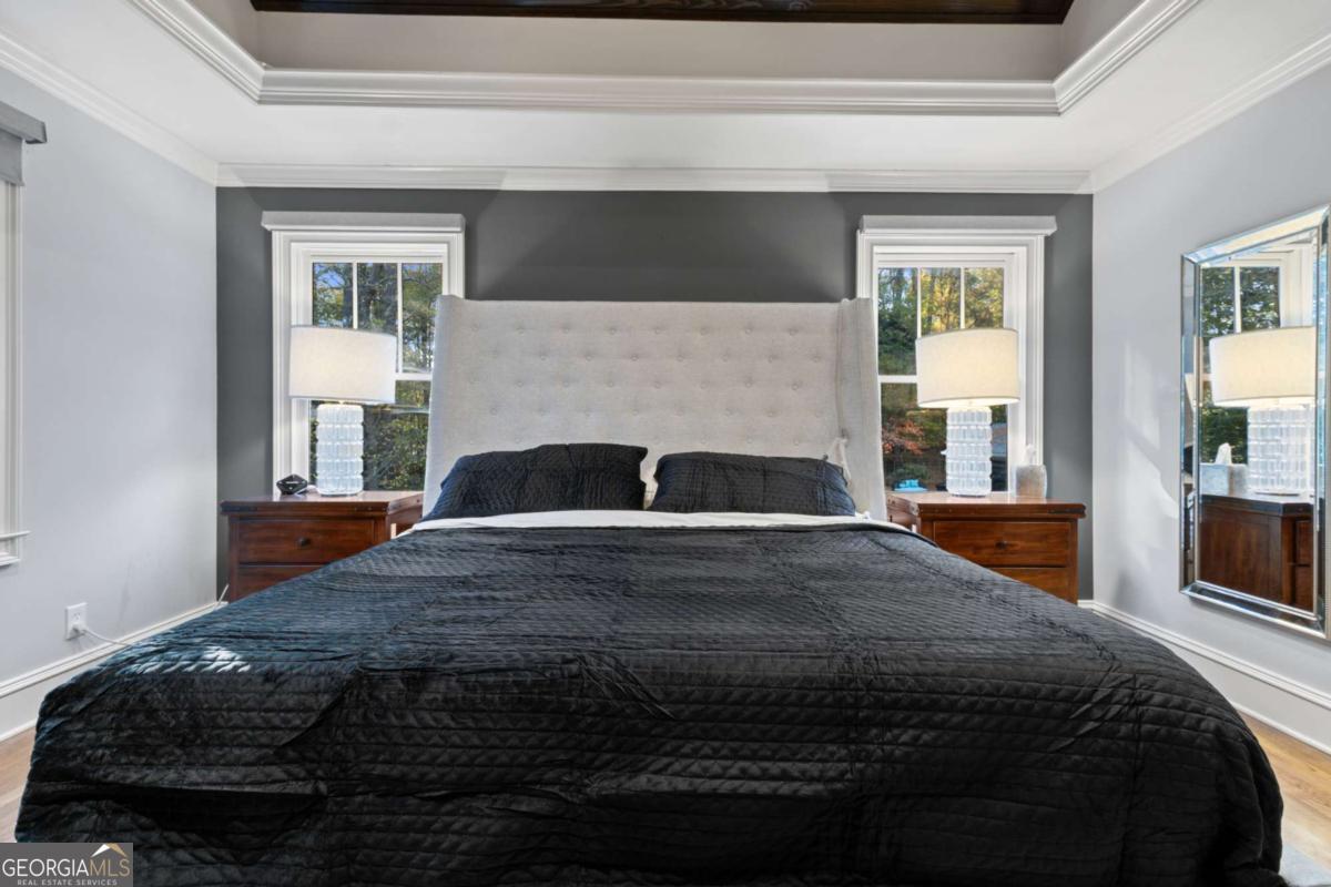 1532 Huntingdon Trail Atlanta, GA 30350 - Photo 34 of 68 a bedroom with a bed and wooden floor