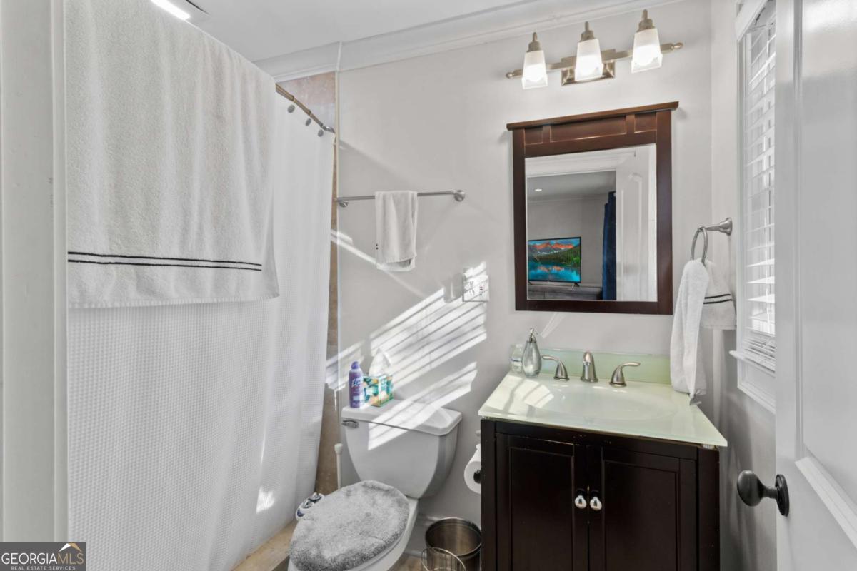 1532 Huntingdon Trail Atlanta, GA 30350 - Photo 49 of 68 a bathroom with a sink vanity mirror and toilet