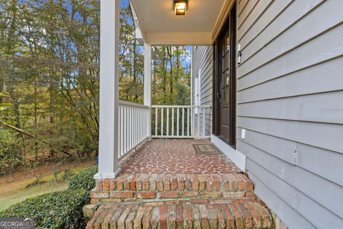 1532 Huntingdon Trail Atlanta, GA 30350 - Photo 5 of 68 a view of backyard with large trees and wooden fence