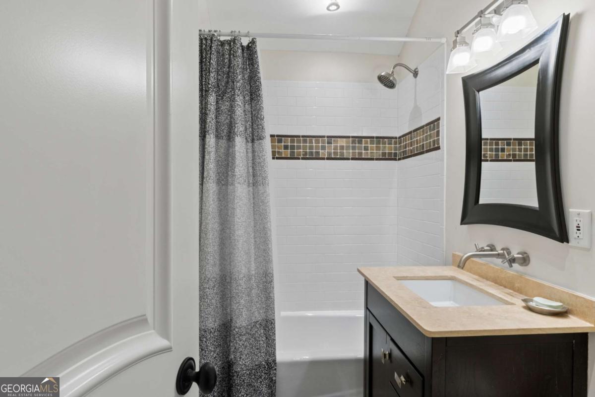 1532 Huntingdon Trail Atlanta, GA 30350 - Photo 63 of 68 a bathroom with a sink vanity and a mirror