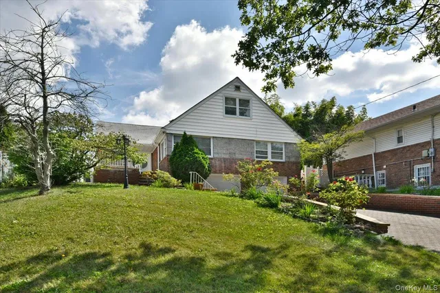 a front view of house with yard and green space