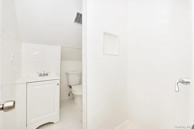 a view of a big room with wooden floor and windows