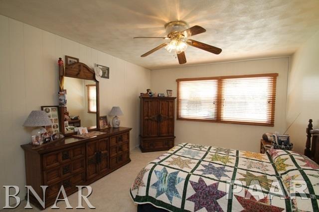25982 Longview Road Hopedale, IL 61747 - Photo 15 of 30 a bed sitting in a bedroom next to a window