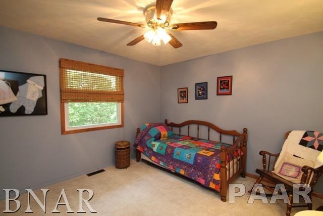 25982 Longview Road Hopedale, IL 61747 - Photo 17 of 30 a bedroom with a bed and a chandelier