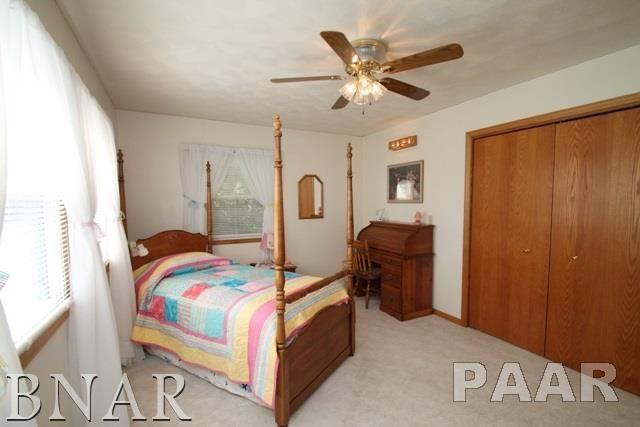 25982 Longview Road Hopedale, IL 61747 - Photo 20 of 30 a bedroom with a bed and a chandelier