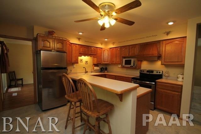 25982 Longview Road Hopedale, IL 61747 - Photo 8 of 30 a kitchen with stainless steel appliances granite countertop a sink refrigerator stove and microwave