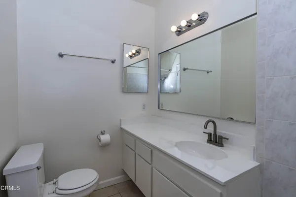 a bathroom with a sink a toilet and mirror