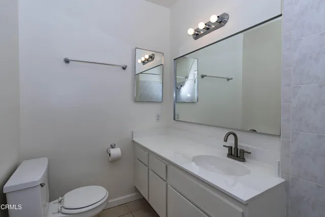 a bathroom with a sink a toilet and mirror