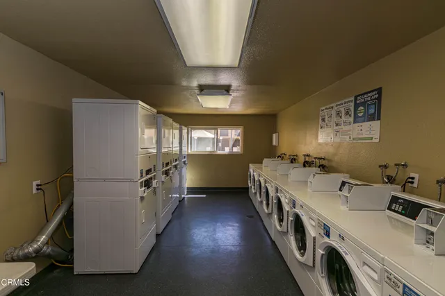 a outdoor space with a couch a rug and a dining table