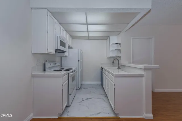 a kitchen with stainless steel appliances a sink stove and cabinets