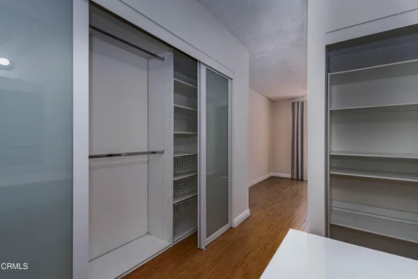 a view of walk in closet with empty racks