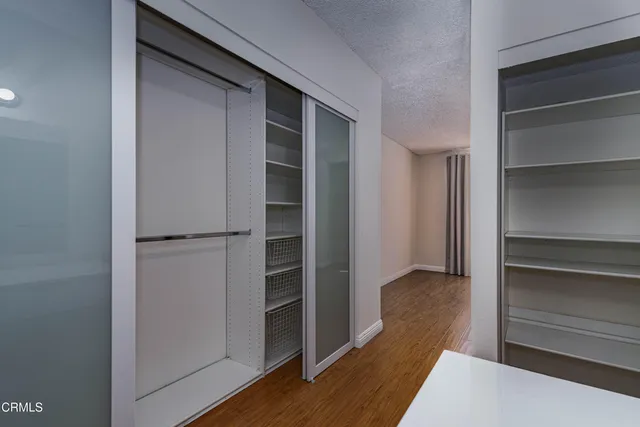 a view of walk in closet with empty racks
