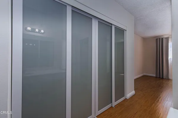 a view of hallway with wooden floor