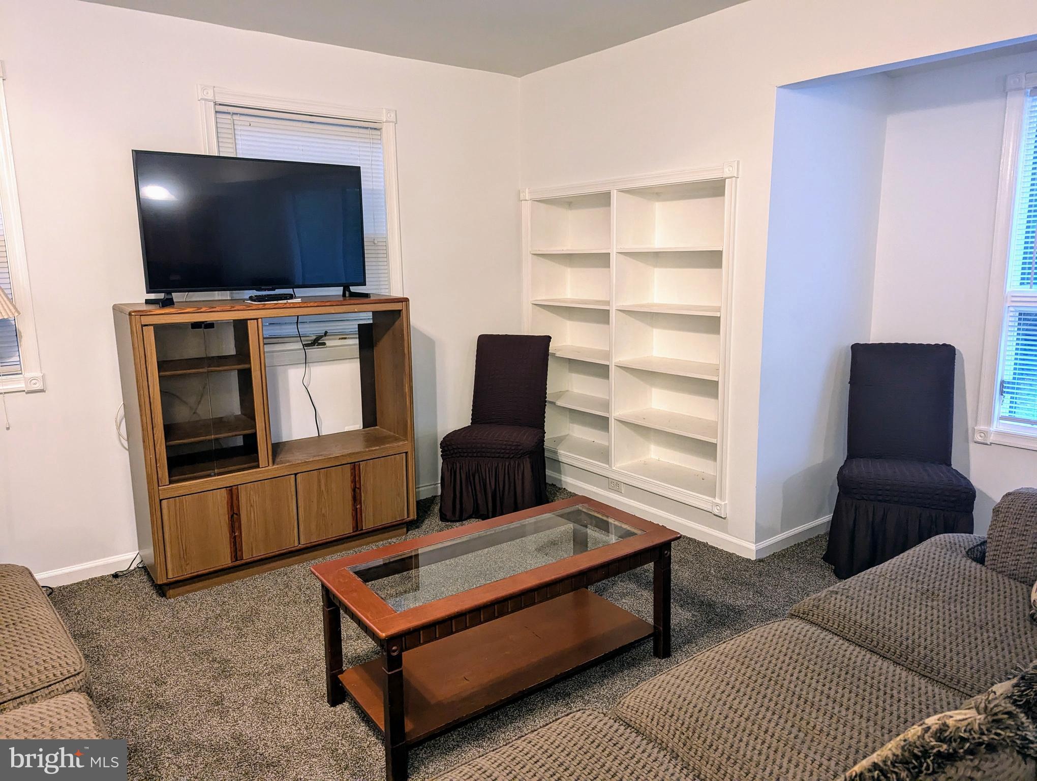 660 Willow Road, Unit A Lusby, MD 20657 - Photo 2 of 8 a living room with furniture and a flat screen tv