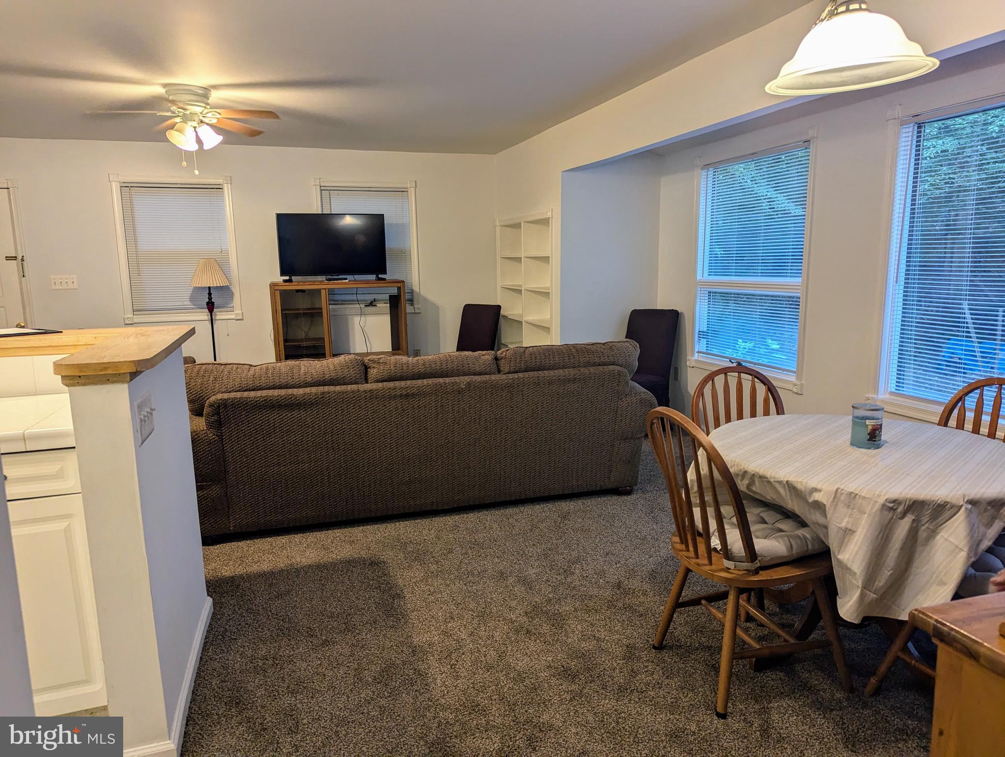 660 Willow Road, Unit A Lusby, MD 20657 - Photo 3 of 8 a living room with furniture and a flat screen tv