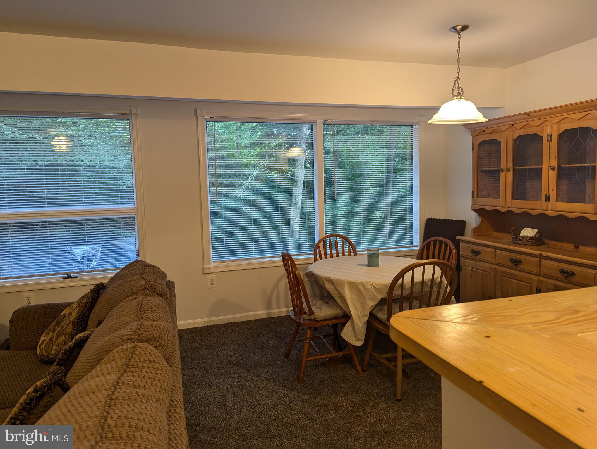 660 Willow Road, Unit A Lusby, MD 20657 - Photo 4 of 8 a dining room with furniture and window