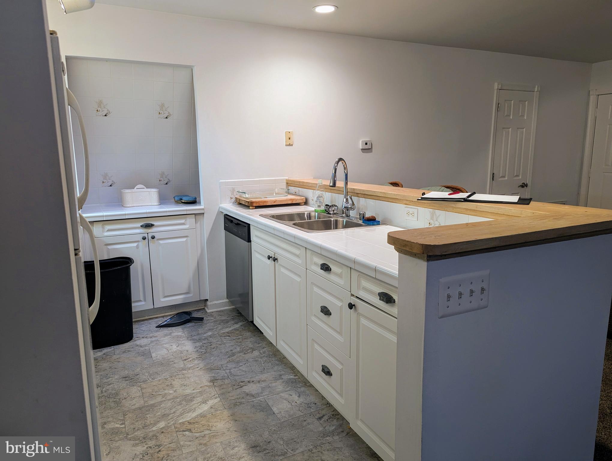 660 Willow Road, Unit A Lusby, MD 20657 - Photo 5 of 8 a spacious bathroom with a sink and a mirror