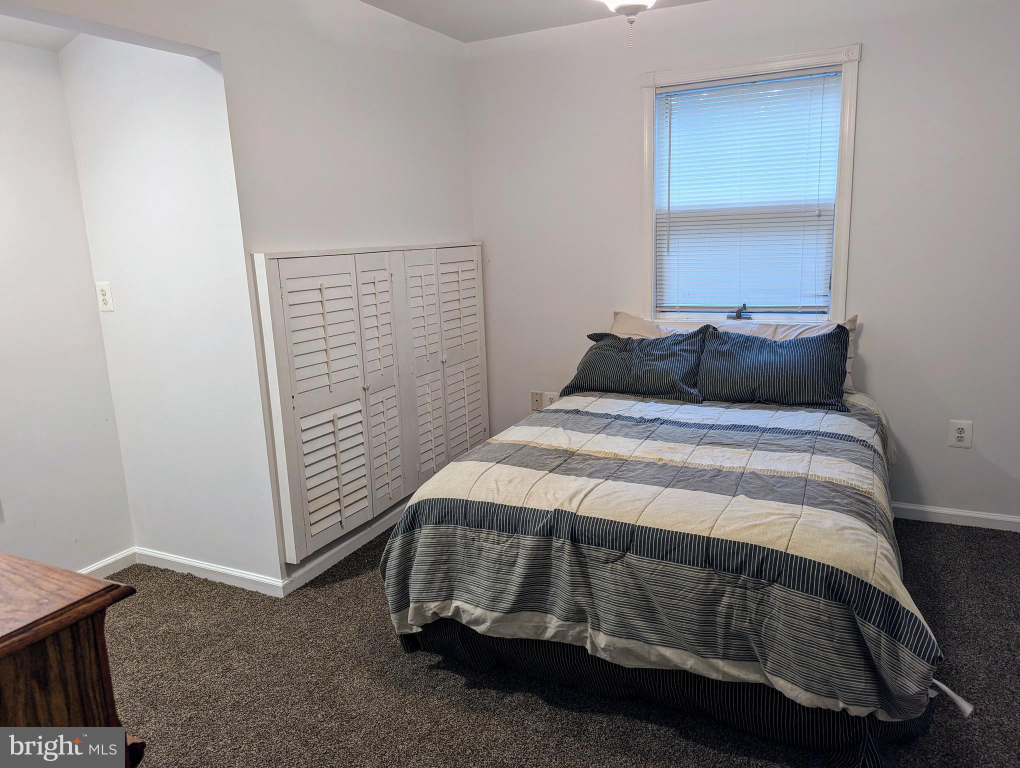 660 Willow Road, Unit A Lusby, MD 20657 - Photo 7 of 8 a bedroom with a bed and a window