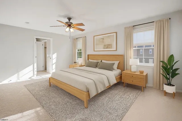 a bedroom with a large bed and a chandelier