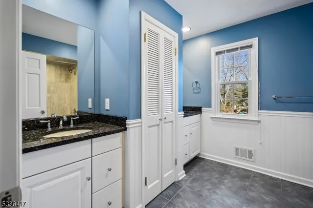 a bathroom with double sink and a mirror