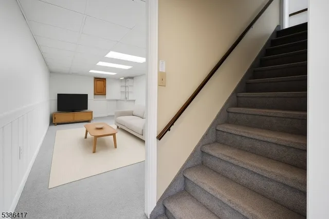 a living room with furniture and a stairs