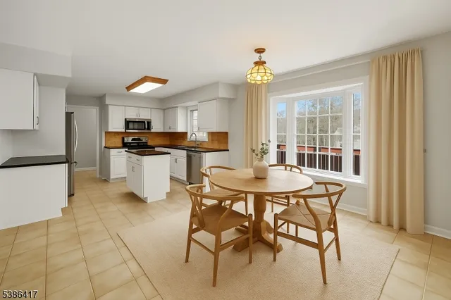 a kitchen with stainless steel appliances kitchen island granite countertop a sink and cabinets