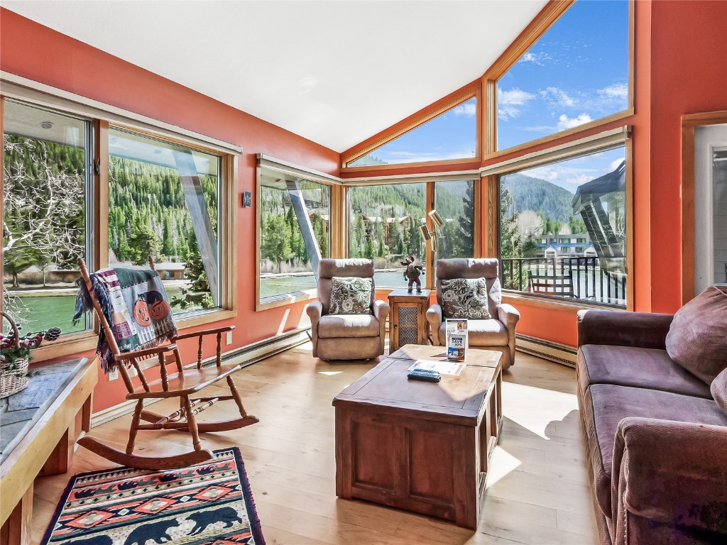 a living room with furniture and a floor to ceiling window