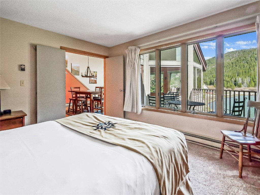 22280 Highway 6, Unit 1717 Keystone, CO 80435 - Photo 11 of 21 a bedroom with a large bed and a large window