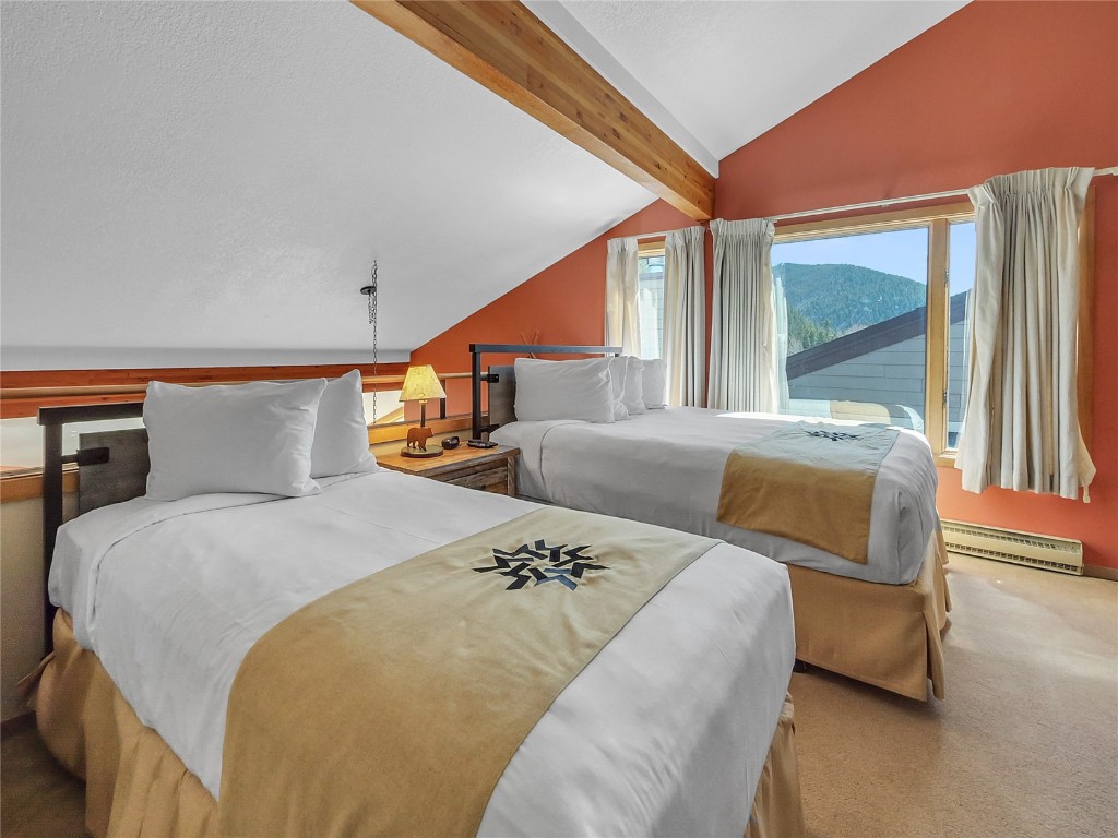 22280 Highway 6, Unit 1717 Keystone, CO 80435 - Photo 13 of 21 a bedroom with a large bed and a large window