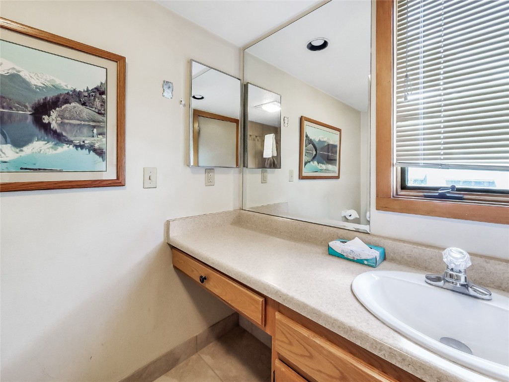22280 Highway 6, Unit 1717 Keystone, CO 80435 - Photo 16 of 21 a bathroom with a sink mirror and vanity