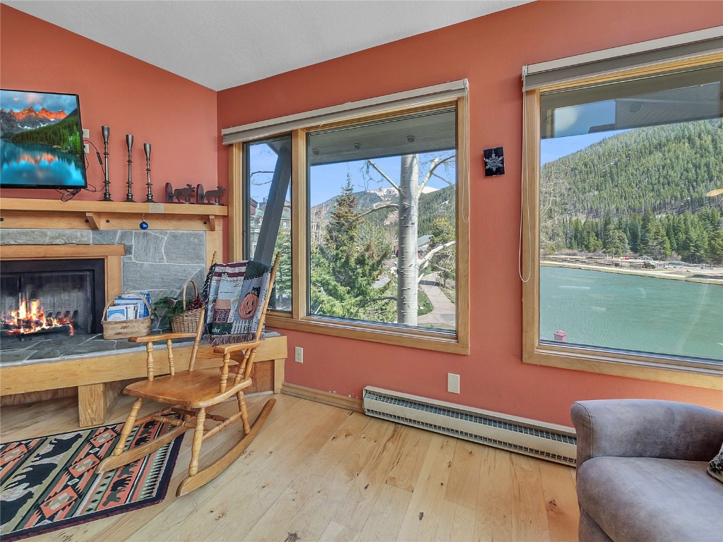 22280 Highway 6, Unit 1717 Keystone, CO 80435 - Photo 3 of 21 a living room with furniture a fireplace and a floor to ceiling window