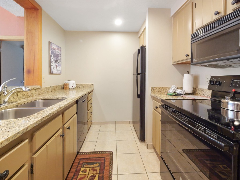 22280 Highway 6, Unit 1717 Keystone, CO 80435 - Photo 8 of 21 a kitchen with stainless steel appliances granite countertop a sink stove and refrigerator