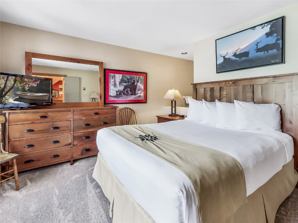 22280 Highway 6, Unit 1717 Keystone, CO 80435 - Photo 9 of 21 a bedroom with a bed and a television