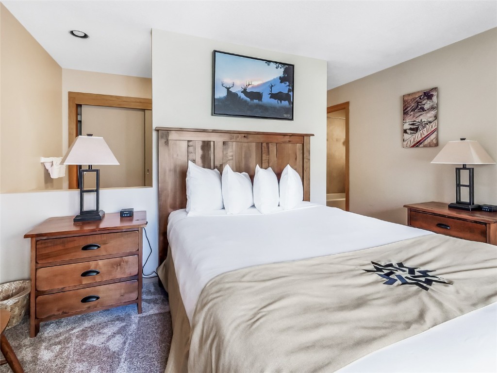 22280 Highway 6, Unit 1717 Keystone, CO 80435 - Photo 10 of 21 a bedroom with a bed and a lamp on dresser
