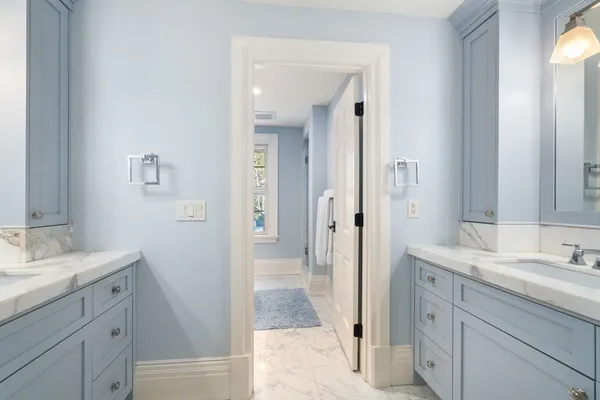 a en suite bathroom with a sink double vanity and mirror