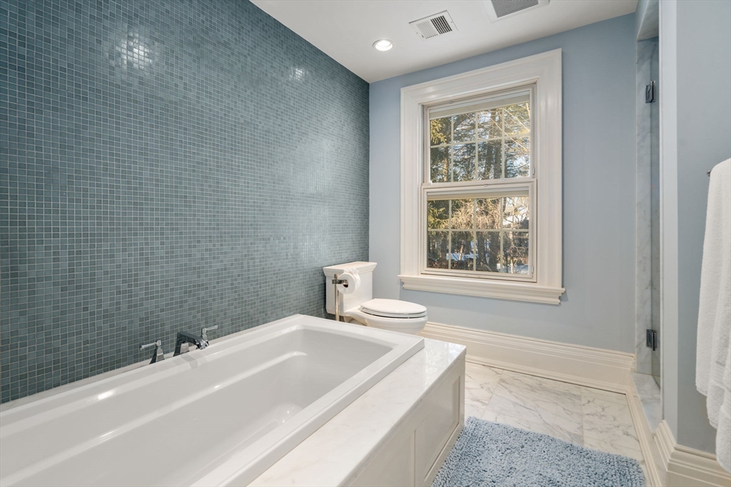 11 Hillcrest Road Weston, MA 02493 - Photo 24 of 42 a bathroom with a tub sink and mirror