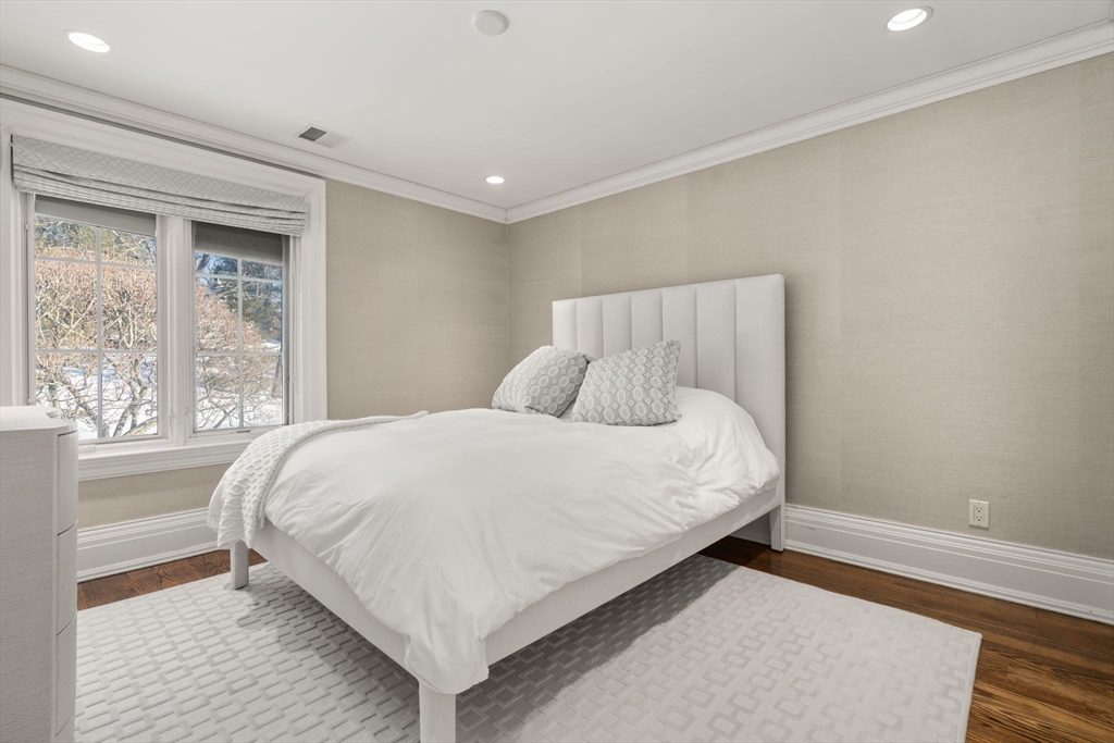 11 Hillcrest Road Weston, MA 02493 - Photo 26 of 42 a large bed sitting in a bedroom next to a window