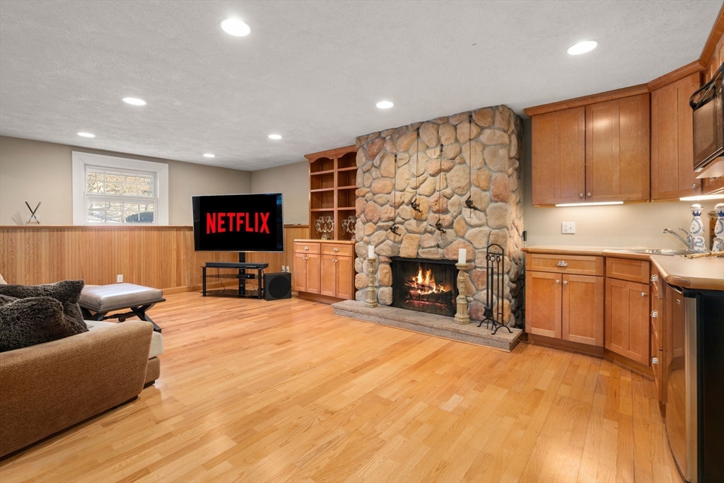 11 Hillcrest Road Weston, MA 02493 - Photo 28 of 42 a living room with furniture and a fireplace