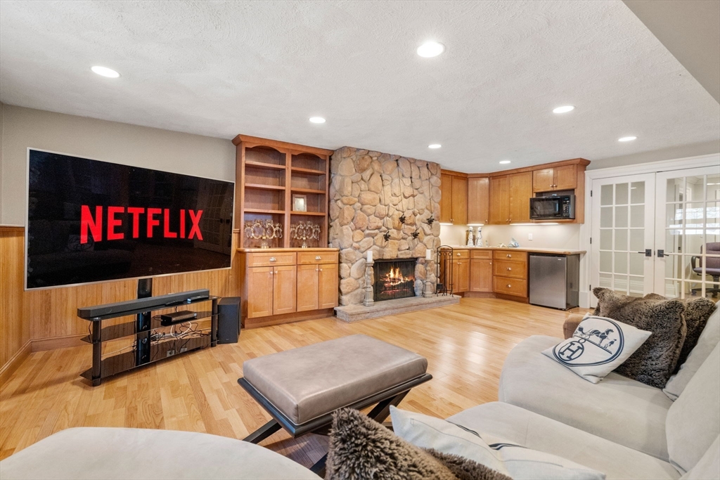 11 Hillcrest Road Weston, MA 02493 - Photo 29 of 42 a living room with fireplace furniture and a flat screen tv